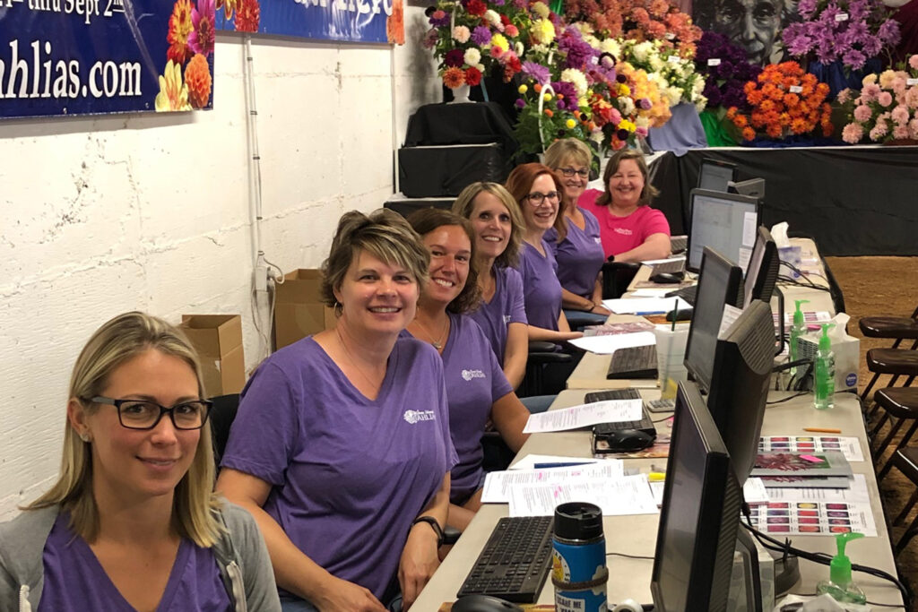 A row of women from the customer service team at the Annual Dahlia Festival